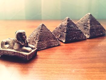 Replica of the sphinx and pyramid on table at home