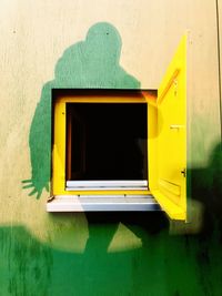 Close-up of yellow window on building