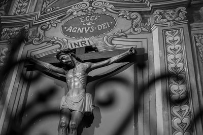 Low angle view of angel statue against building