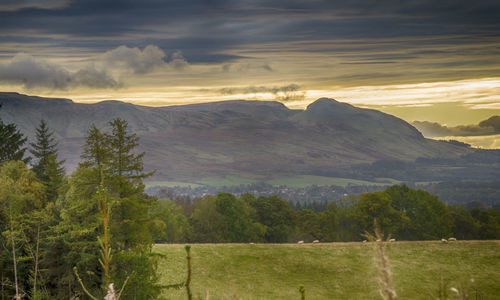 Scenic view of mountains against cloudy sky