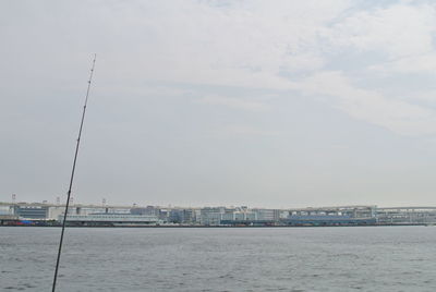 Scenic view of sea against sky in city