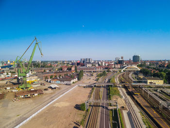 High angle view of city against blue sky