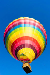 Low angle view of hot air balloon against blue sky