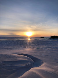 Scenic view of lake against sky during sunset