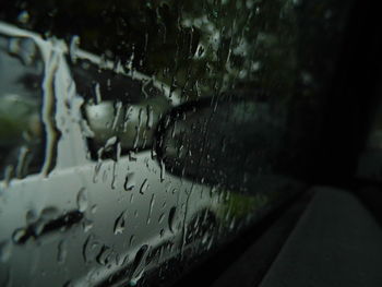 Close-up of raindrops on car windshield