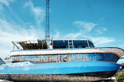 Low angle view of abandoned boat against sky