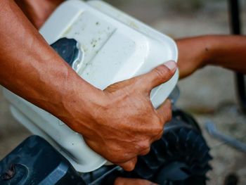 Hand holding up a motorcycle engine