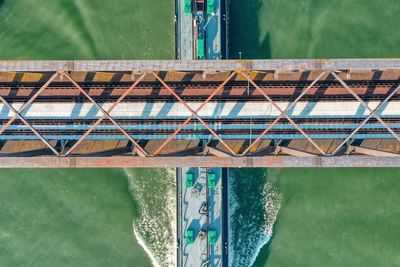 Aerial view of ship passing under bridge