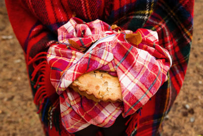 Close-up of hand holding red leaf outdoors