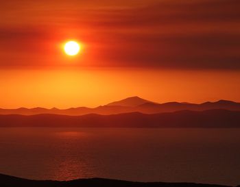 Scenic view of sea against romantic sky at sunset