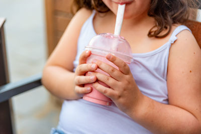 Midsection of a woman drinking glass