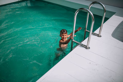 Portrait of smiling boy in swimming pool