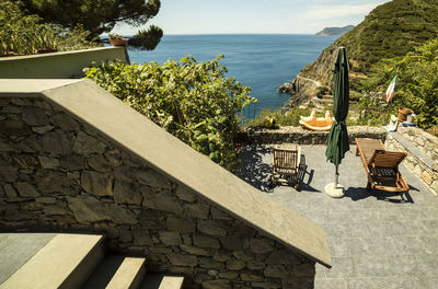 Scenic view of deck chair against clear sky