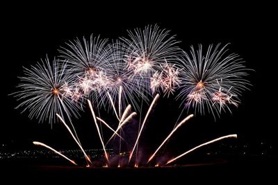 Low angle view of firework display against sky at night