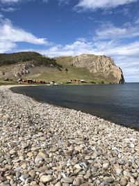 Rocks on beach against sky