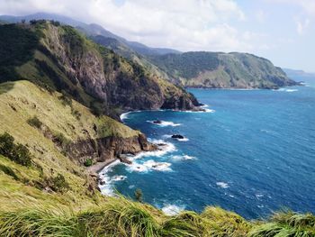 Scenic view of sea and mountains against sky