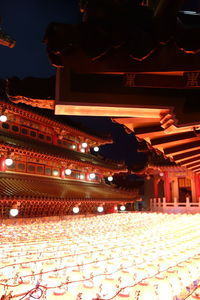 Low angle view of illuminated buildings at night