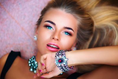 Close-up portrait of beautiful young woman wearing jewelries