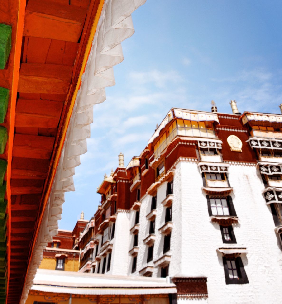 architecture, building exterior, built structure, sky, residential building, low angle view, residential structure, window, building, house, balcony, city, day, old town, cloud, outdoors, sunlight, facade, in a row, no people