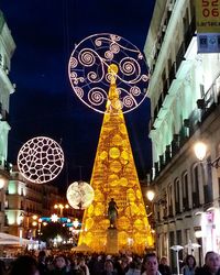 Low angle view of illuminated people at night