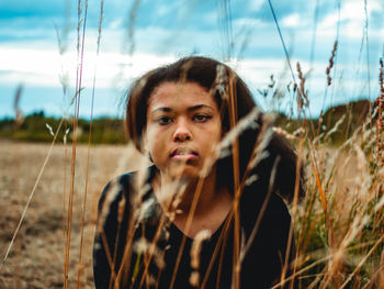 Portrait of teenage girl on field