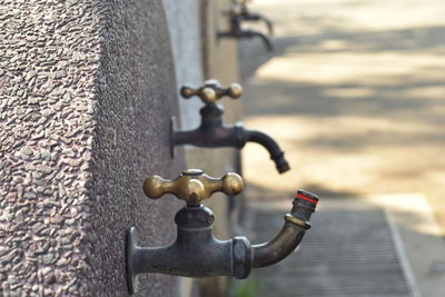 Close-up of drinking fountains on wall