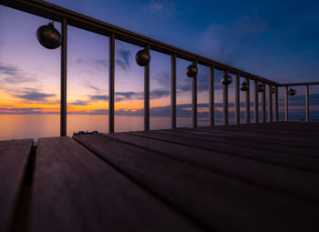 Balcony over sea against sky during sunset