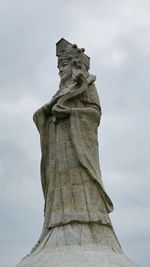 Low angle view of statue against cloudy sky