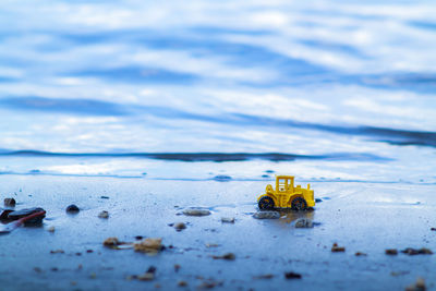 Close-up of toy car on beach