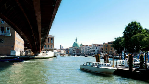 Views of venice, grand canal, under the bridge small boats, gondolas sail, on a hot summer day