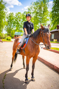 Rear view of woman riding horse