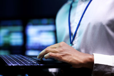 Midsection of man using laptop