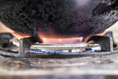 Close-up of burning candles on metal