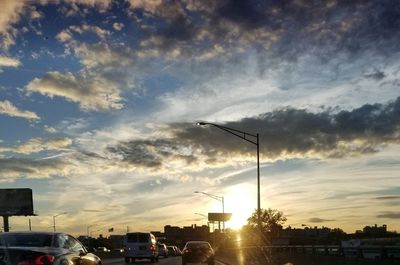 Low angle view of street light against dramatic sky