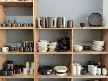 Kitchen utensils in shelf at home