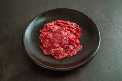 High angle view of red meat in plate