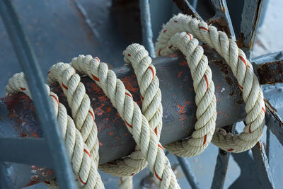 Close-up of rope tied on metal in boat