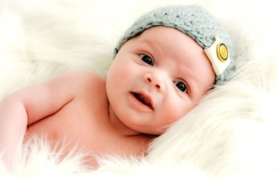 Portrait of cute baby girl lying on wool