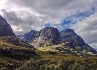 Scenic view of mountains against cloudy sky