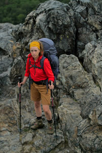 Full length portrait of woman holding hiking poles