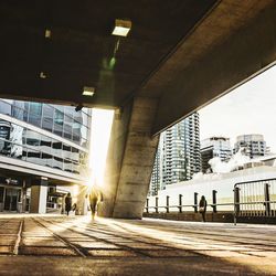 Silhouette of people walking in city