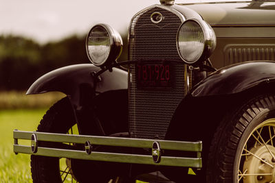 Close-up of vintage car on field