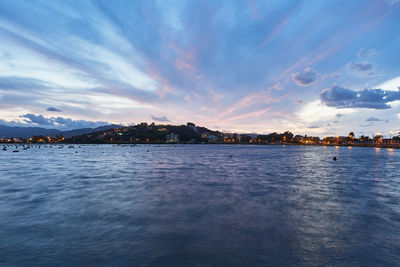 Scenic view of river against sky at sunset