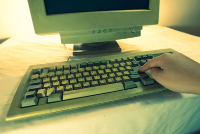 Midsection of person using laptop on table