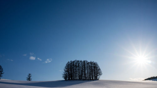 Scenic view of snow field against clear blue sky