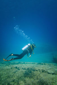 Woman scuba diving in sea