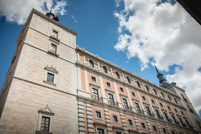 Low angle view of building against cloudy sky