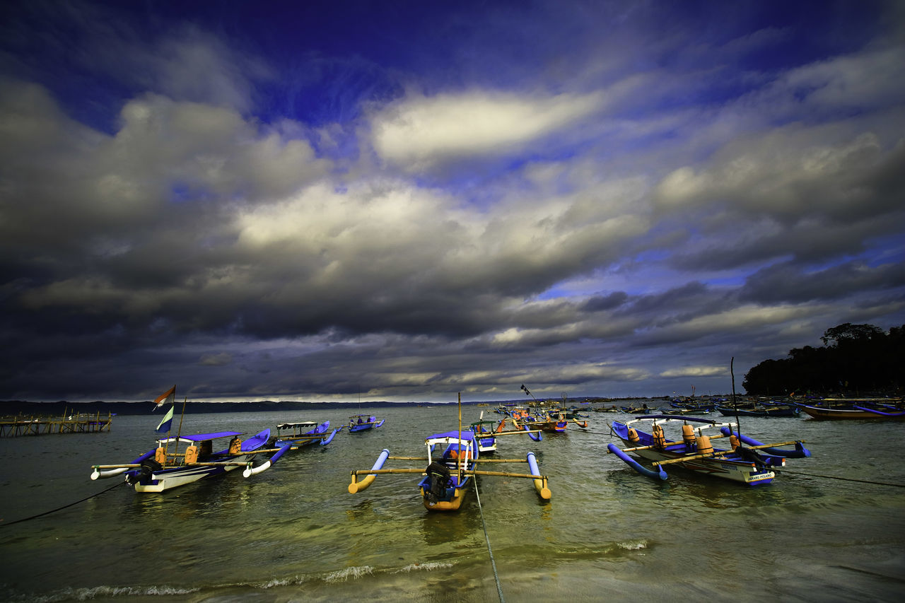 BOATS MOORED ON SEA AGAINST SKY