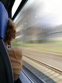 Cropped image of woman sitting in train