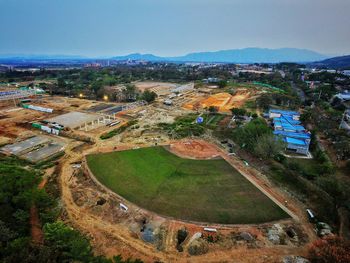 High angle view of playground in city against sky